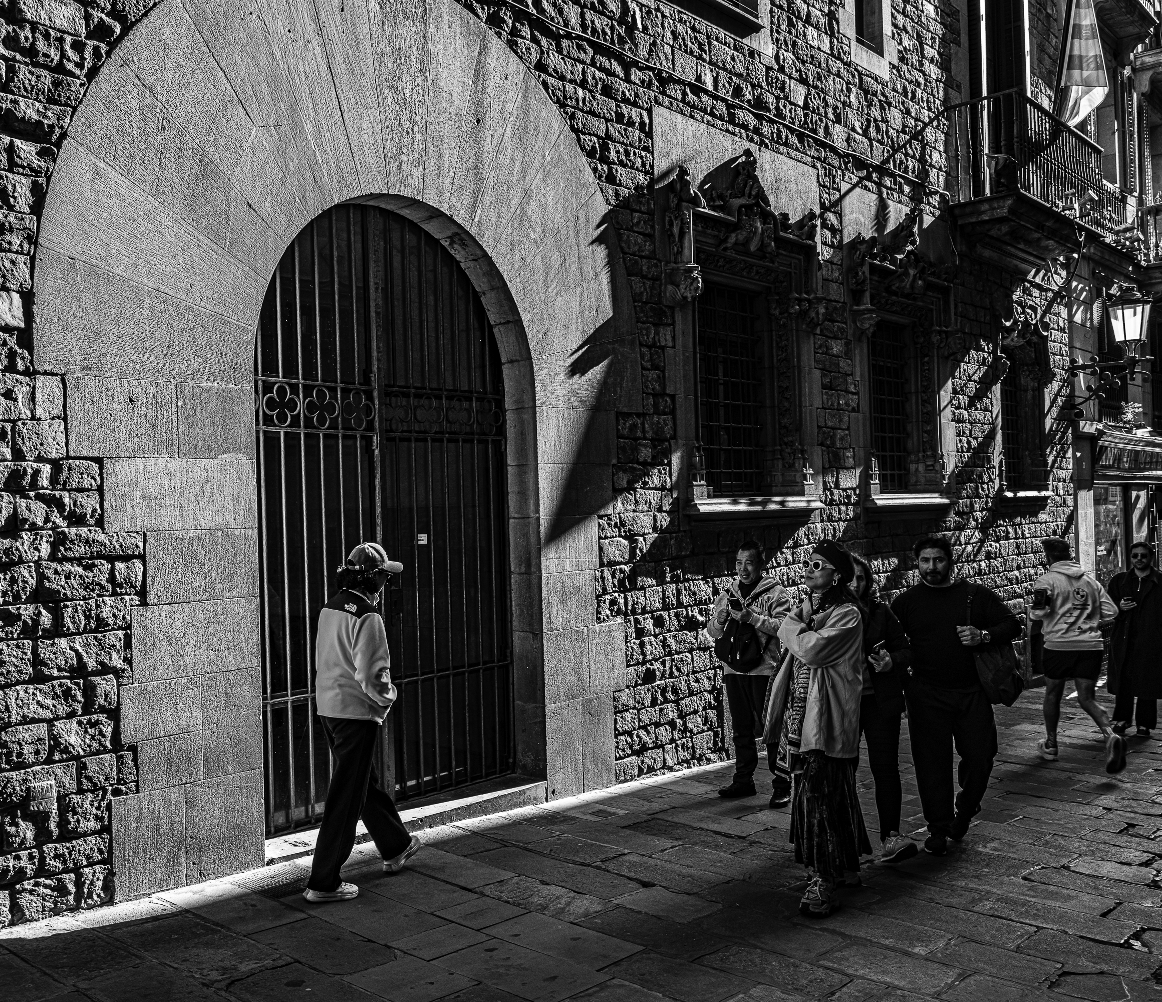 Turistas pasando bajo el puente, móviles en alto, sin detenerse