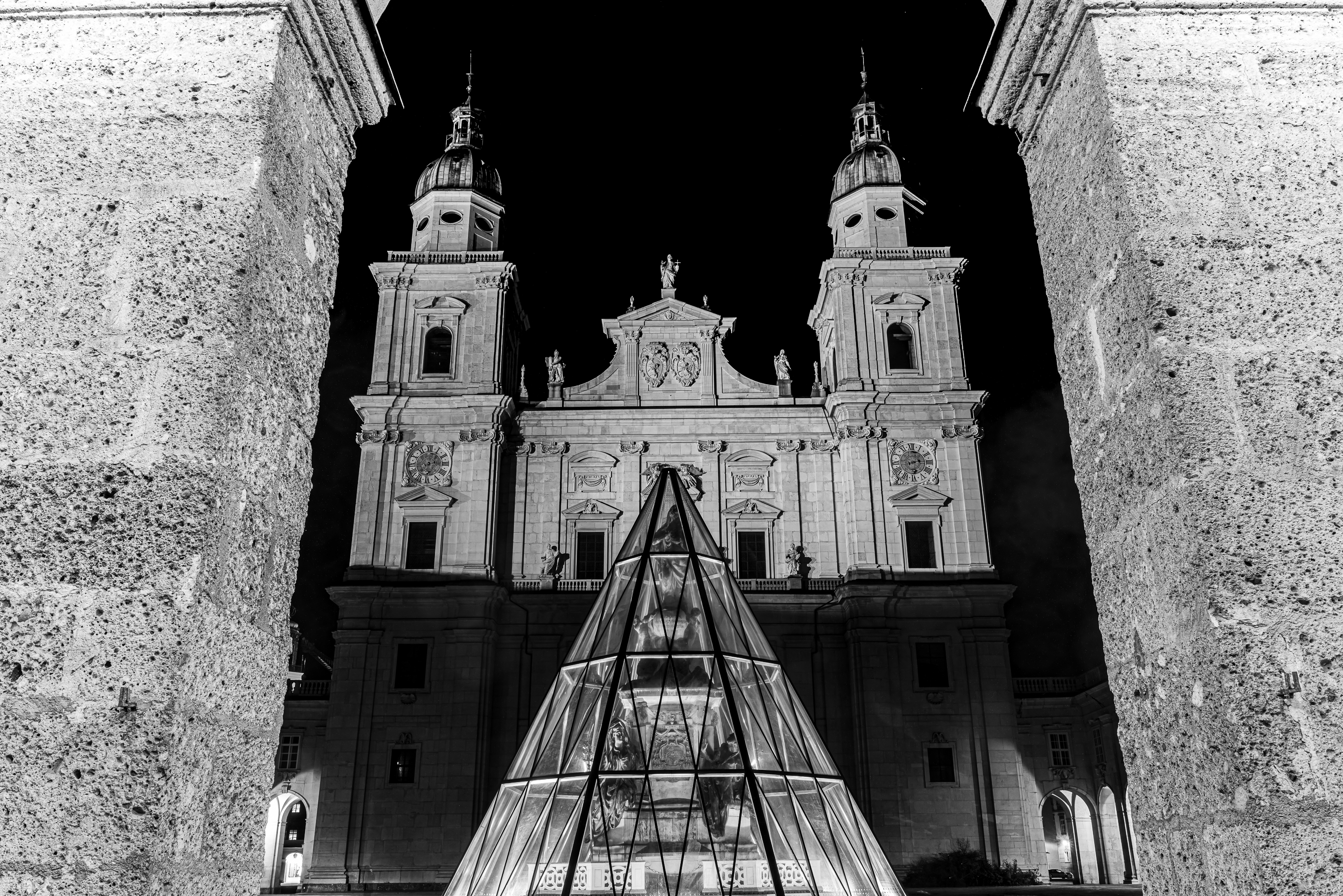 Salzburg Cathedral framed in stone arch, night