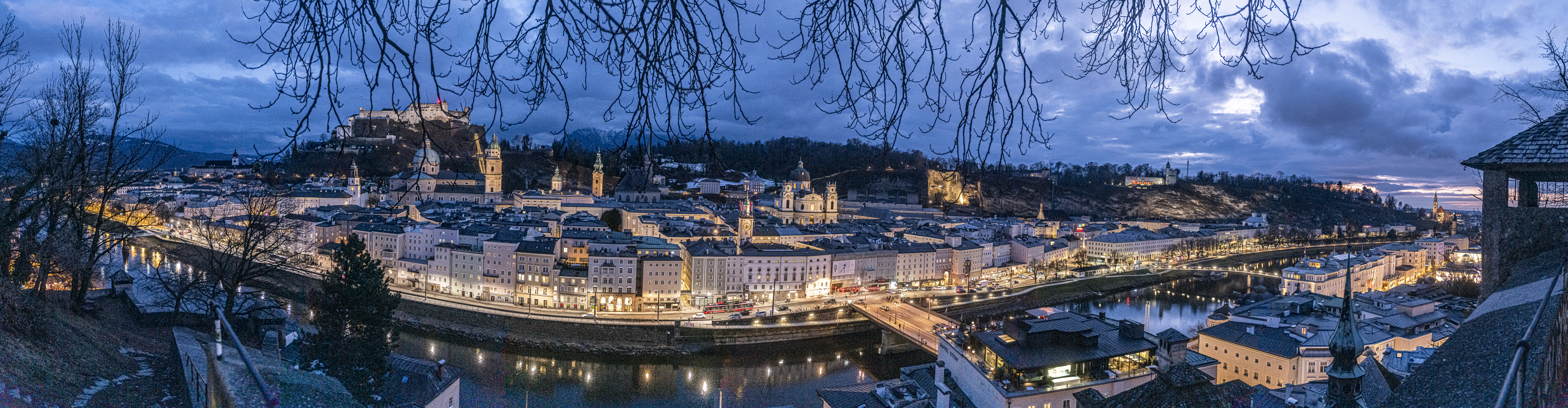 Panorama of Salzburg from the Kapuzinerberg, bare branches, blue hour