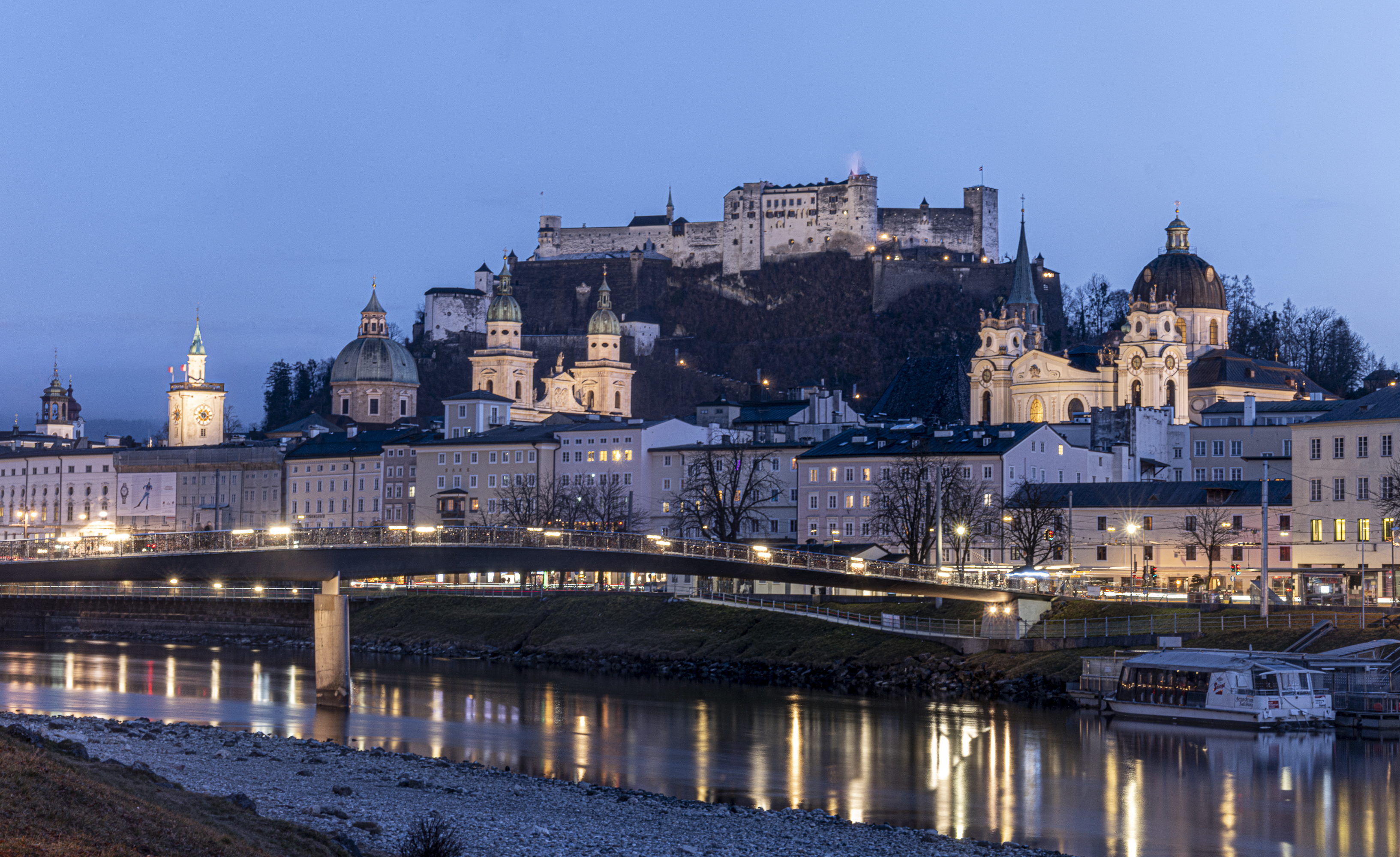 Salzburg skyline reflected in the Salzach, bridge, blue hour